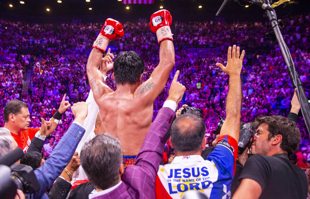 Manny Pacquiao celebrates with the crowd after defeating Keith Thurman in their WBA super welte ...