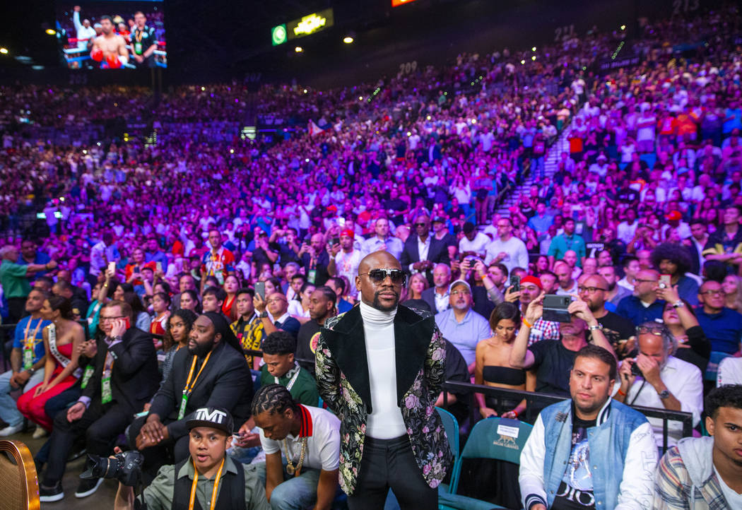Former boxer Floyd Mayweather Jr. watches as Manny Pacquiao and Keith Thurman enter the ring du ...