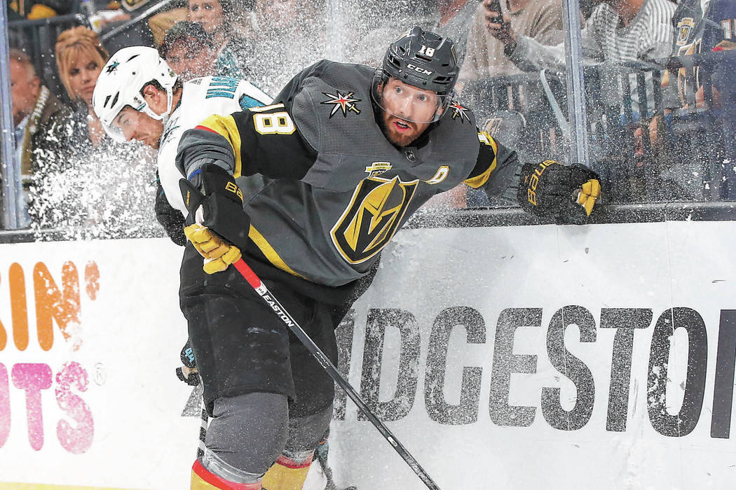 Golden Knights left wing James Neal (18) battles for the puck against San Jose Sharks defensema ...