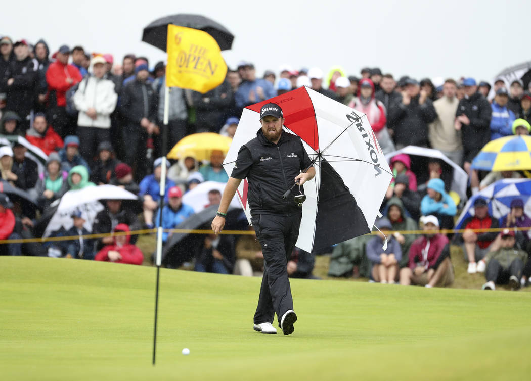 Ireland's Shane Lowry walks with his umbrella on the 6th green during the final round of the Br ...