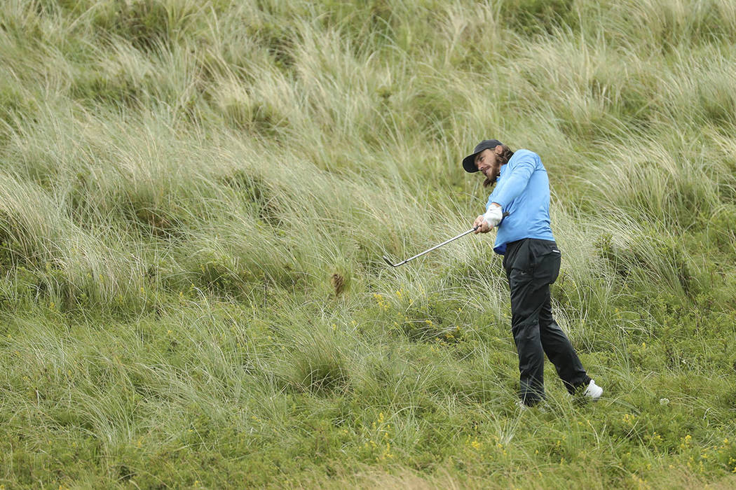 England's Tommy Fleetwood plays from the rough on the 7th hole during the final round of the Br ...