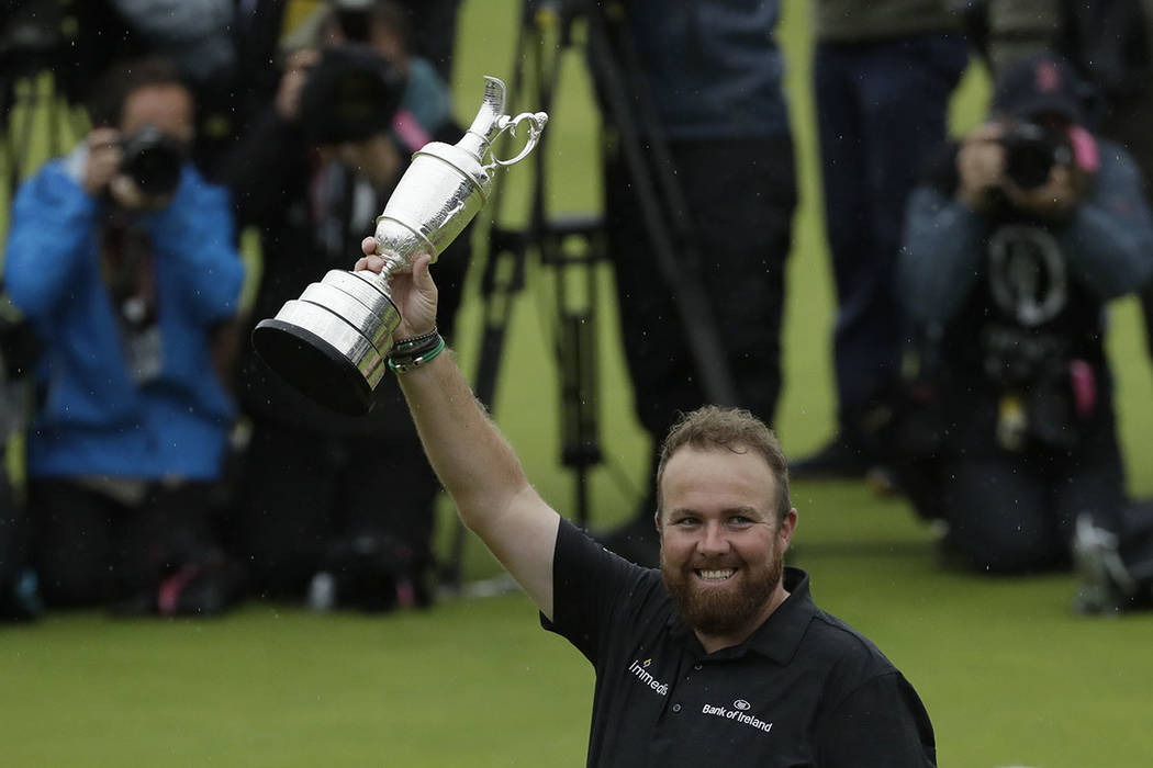 Ireland's Shane Lowry holds up the Claret Jug trophy after winning the British Open Golf Champi ...