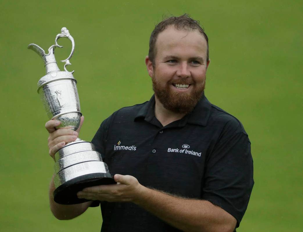 Ireland's Shane Lowry holds up the Claret Jug trophy after winning the British Open Golf Champi ...