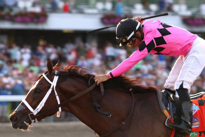 In this image provided by Bill Denver/EQUI-PHOTO, Inc., Luis Saez, top, reacts after guiding Ma ...