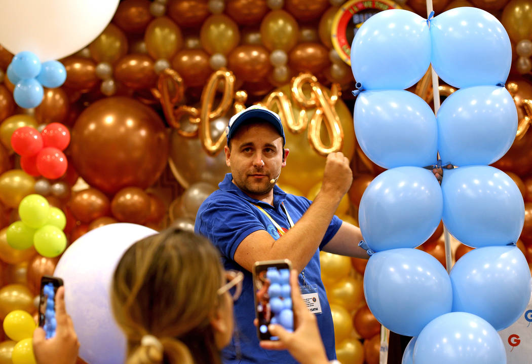 Gergo Lufis Vilaga, a balloon artist from Hungary, leads a workshop on how to make a balloon ba ...