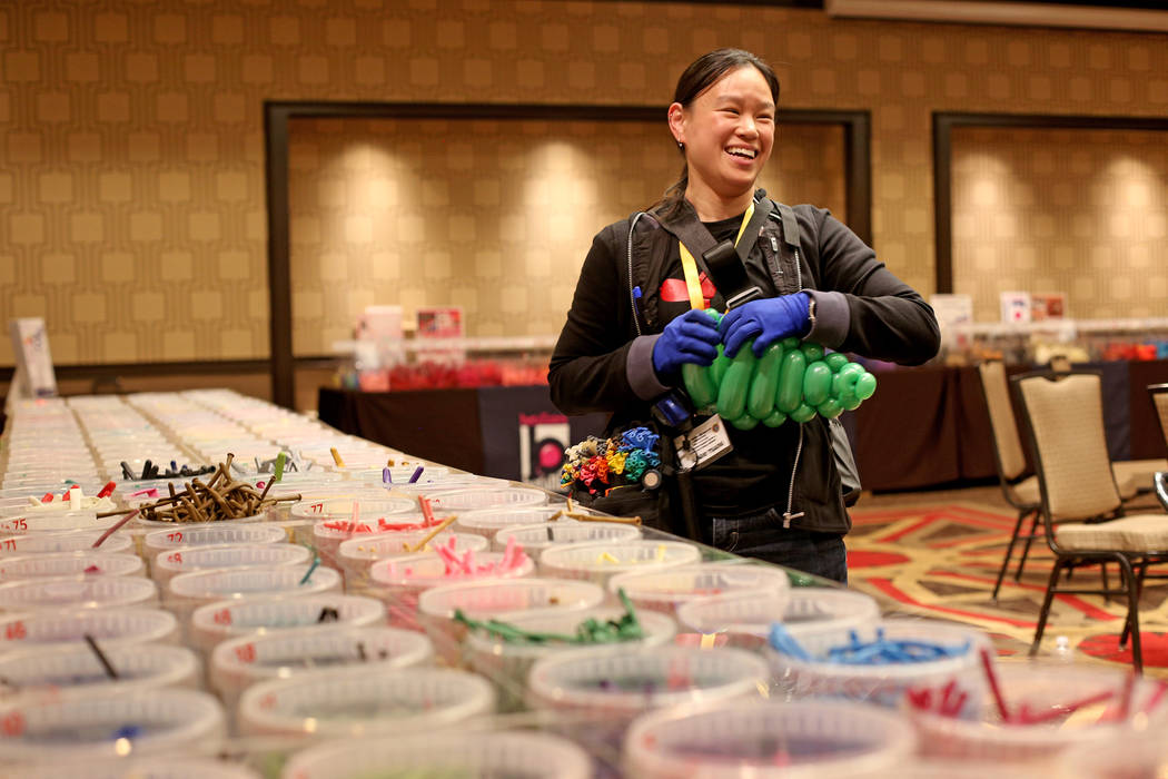 Angie Tsang of California plays with balloon twisting at the Bling Bling Balloon Jam convention ...
