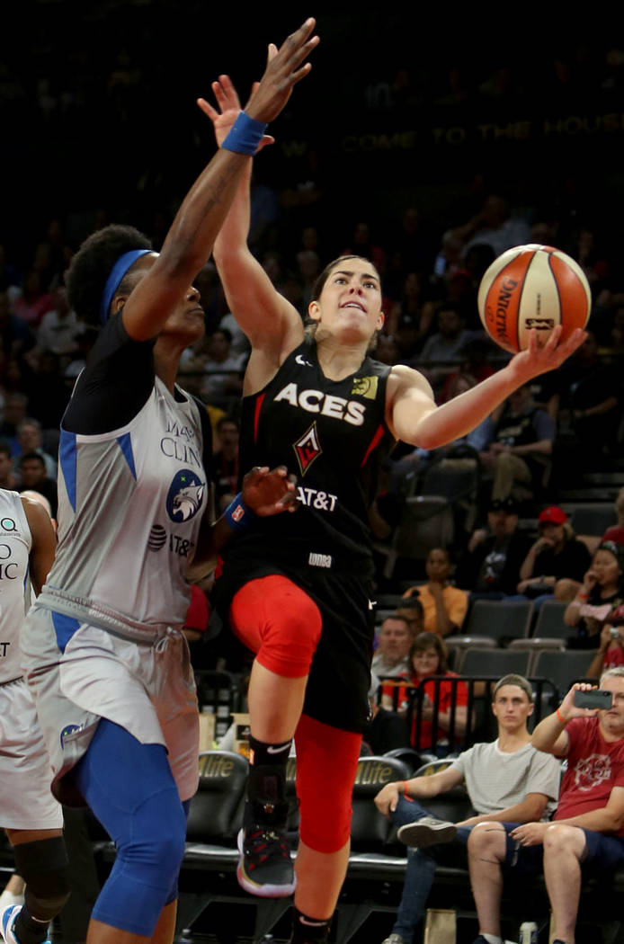 Las Vegas Aces point guard Kelsey Plum (10), right, fights to the hoop against Minnesota Lynx c ...