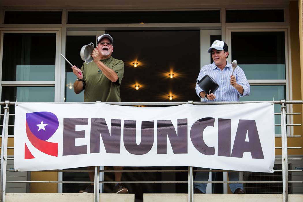 Demonstrators bang on pots, from the balcony of their apartment as they protest against governo ...