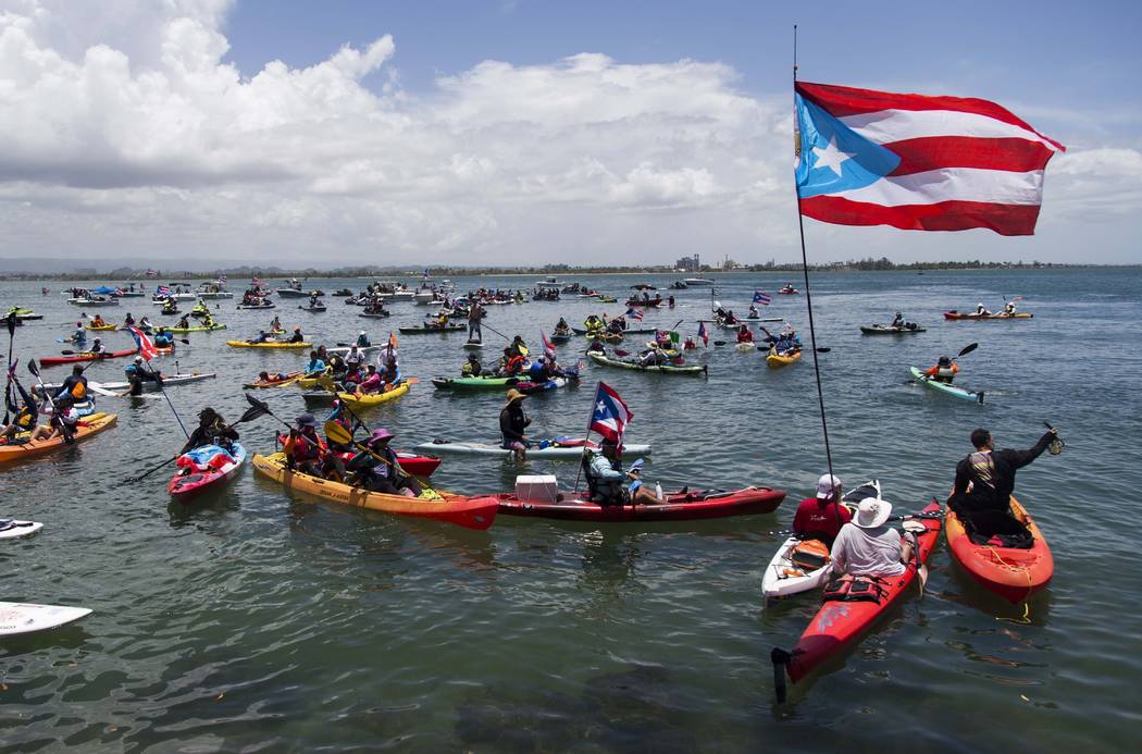 Demonstrators in kayaks gathered in front of La Fortaleza for an aquatic protest against Puerto ...