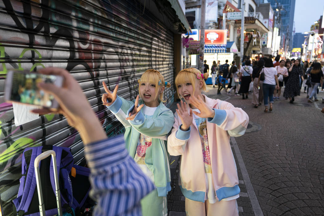 Twins, who go by Kunika and Kuniho, 17, record a greeting for their social media followers in t ...