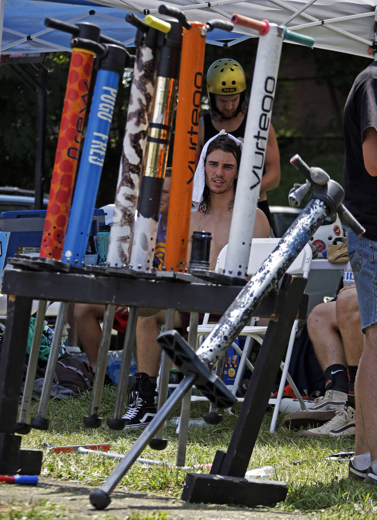 Tyler Phillips of Tampa, Fla., center, keeps cool in the competitor's tent between performances ...