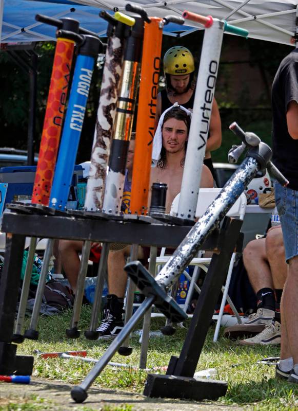 Tyler Phillips of Tampa, Fla., center, keeps cool in the competitor's tent between performances ...