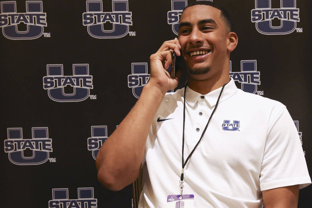 Utah State quarterback Jordan Love does a phone interview during Mountain West football media d ...