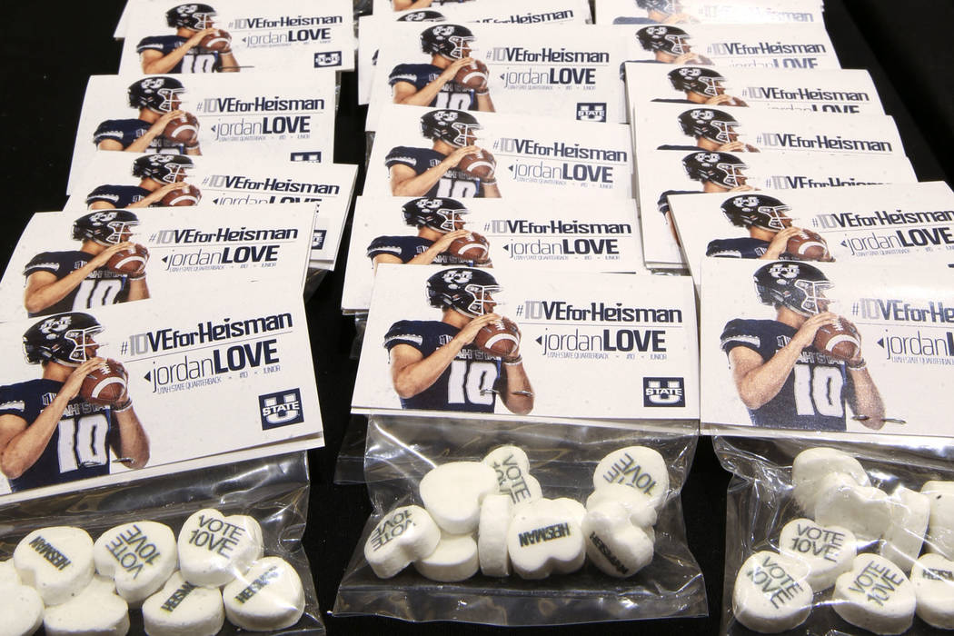 Candy promoting Utah State quarterback Jordan Love as a Heisman Trophy candidate sits among pre ...