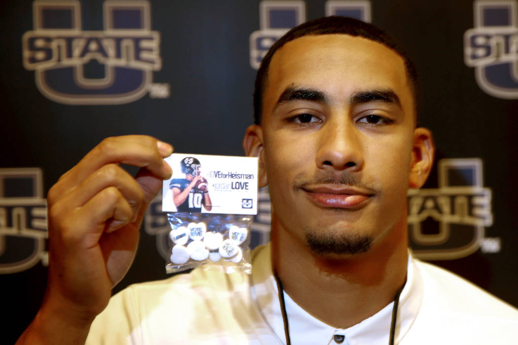 Utah State quarterback Jordan Love holds promotional candy during Mountain West football media ...