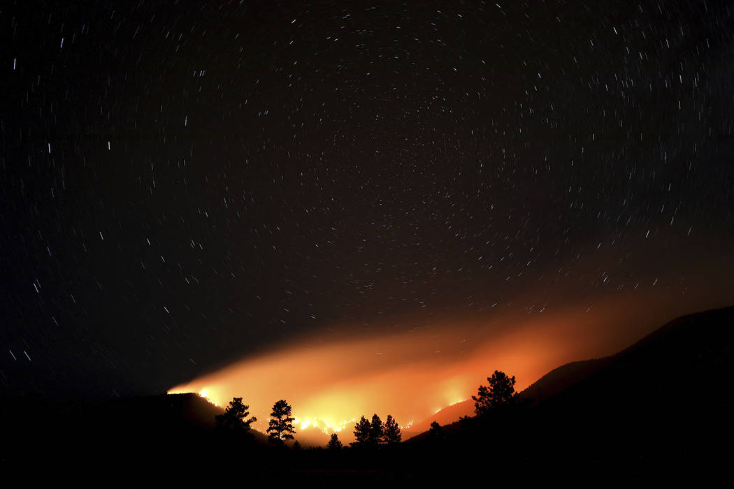 Pockets wildfires within the Museum fire create an ocean of light lapping at the slopes of the ...