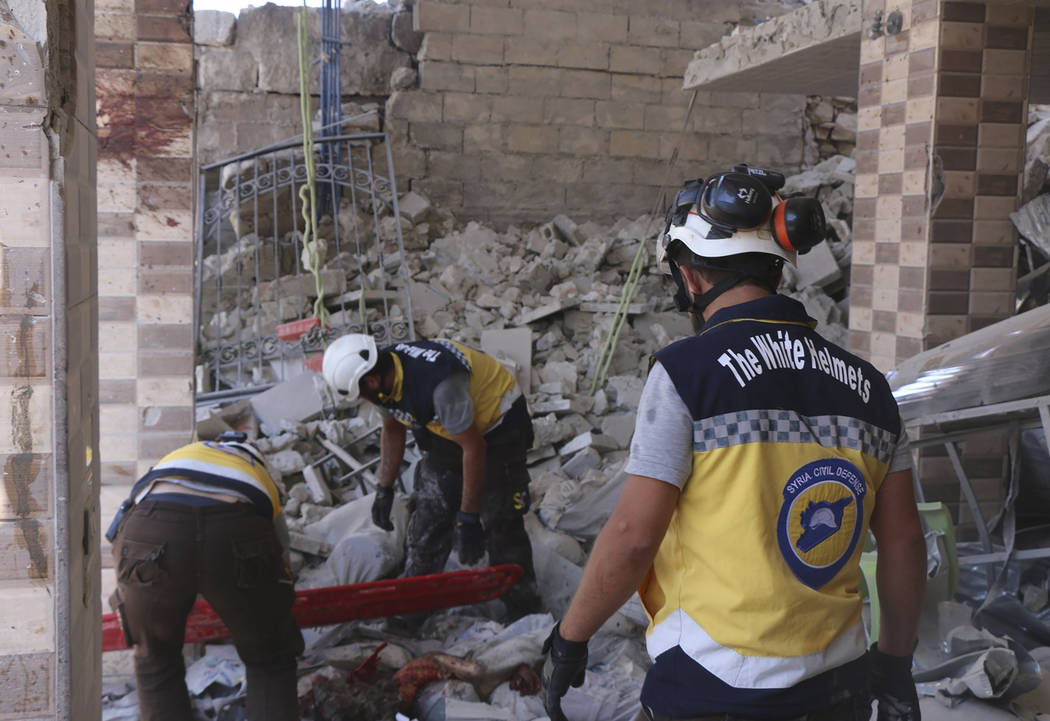 This photo provided by the Syrian Civil Defense White Helmets, which has been authenticated bas ...