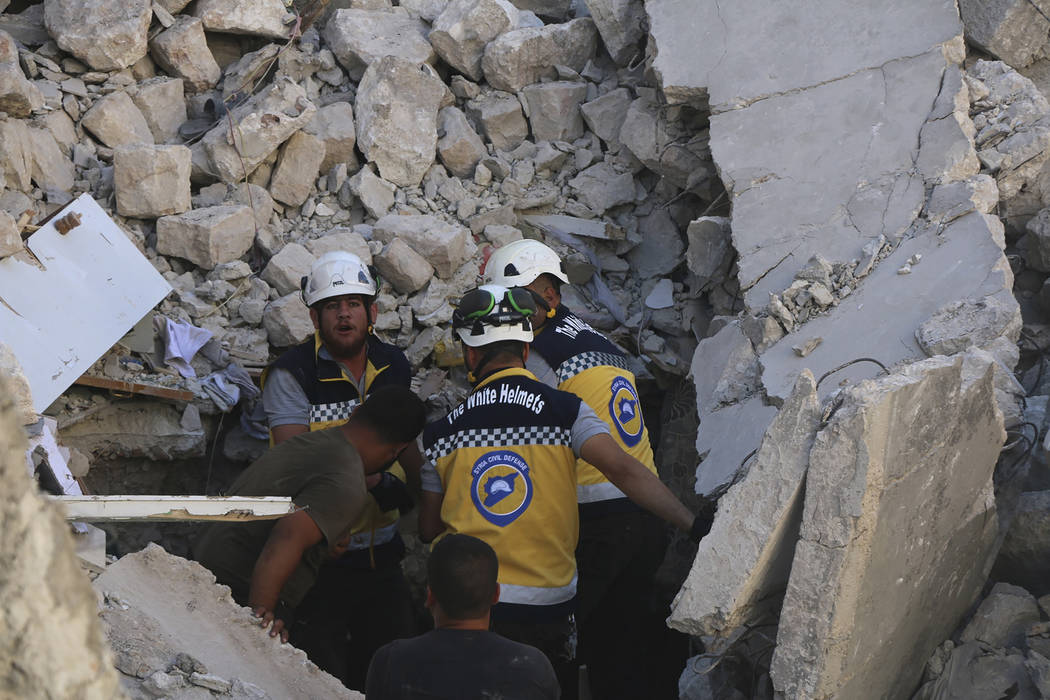 This photo provided by the Syrian Civil Defense White Helmets, which has been authenticated bas ...