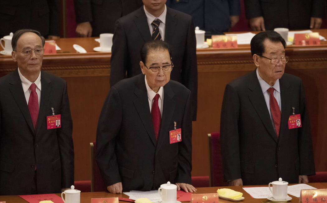 In this Oct. 24, 2017, photo, former Chinese Premier Li Peng, center, attends the closing sessi ...