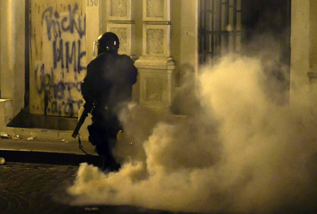 A member of the riot control units patrol the street during clashes in San Juan, Puerto Rico, M ...