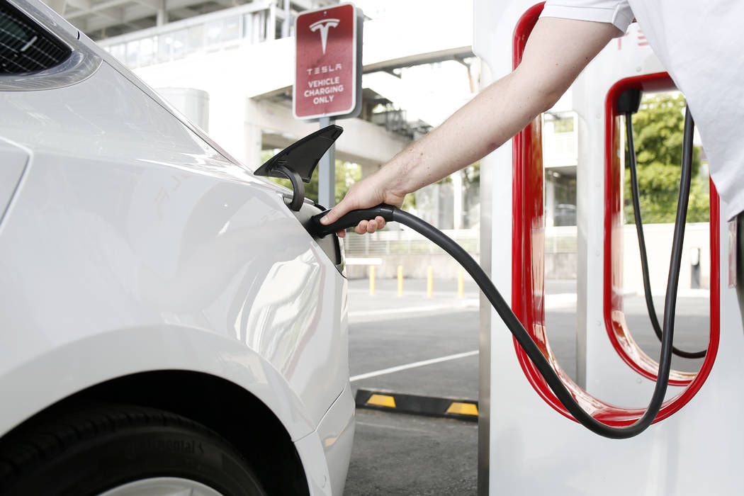 Tesla's Model X is charged at the largest Tesla Supercharger station now open near the High Rol ...