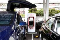 Tesla's Model X is charged by V3 Supercharger at the largest Tesla Supercharger station now ope ...