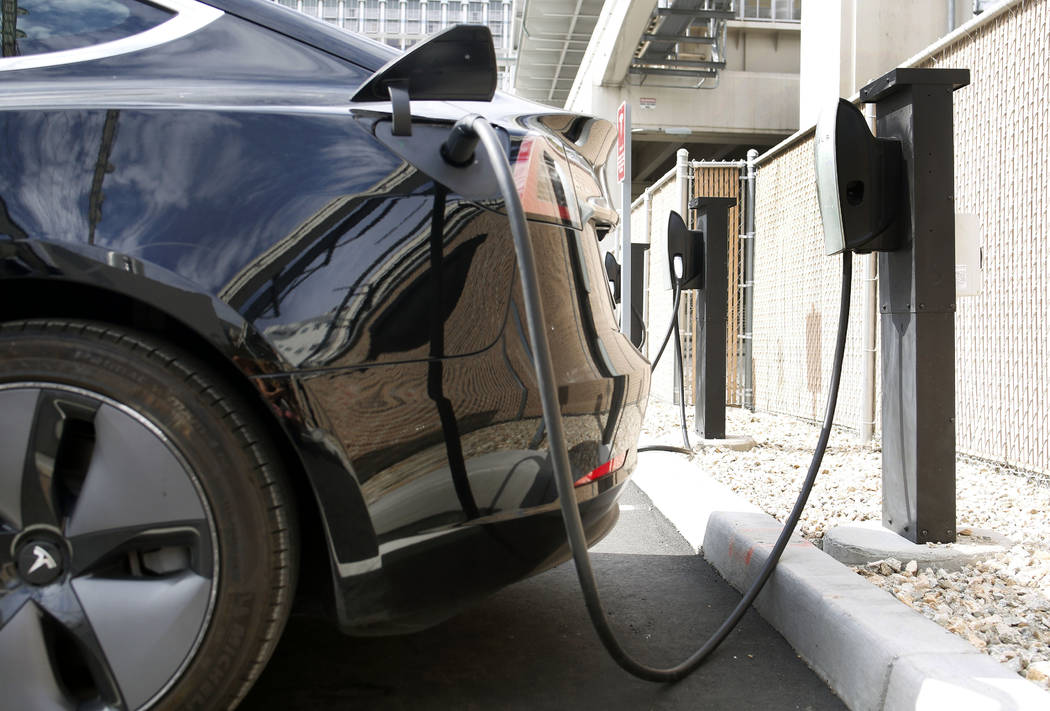 A Tesla is charged by a level 2 charger at Tesla's largest Supercharging station now open near ...