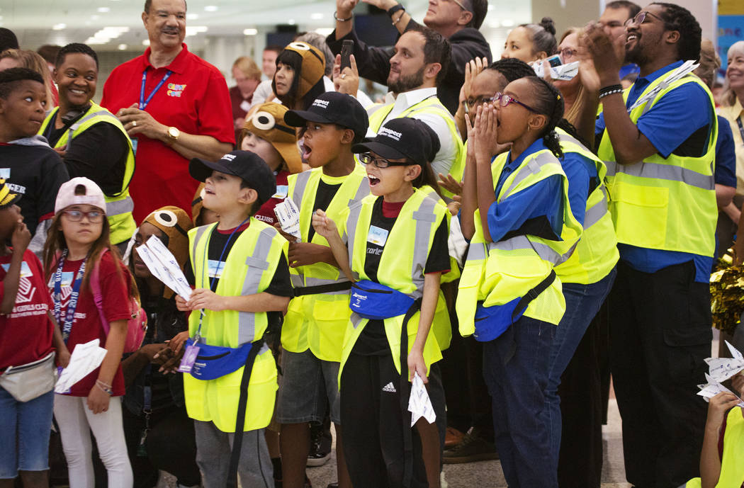 Participants cheer during the seventh annual Paper Plane Palooza in Terminal 3 at McCarran Inte ...