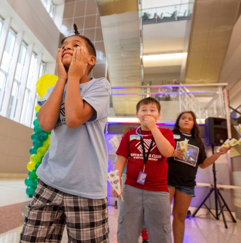 Jaime Rodriguez, 9, looks in shock, as his paper plane becomes stuck by a mirror, as Connor Par ...