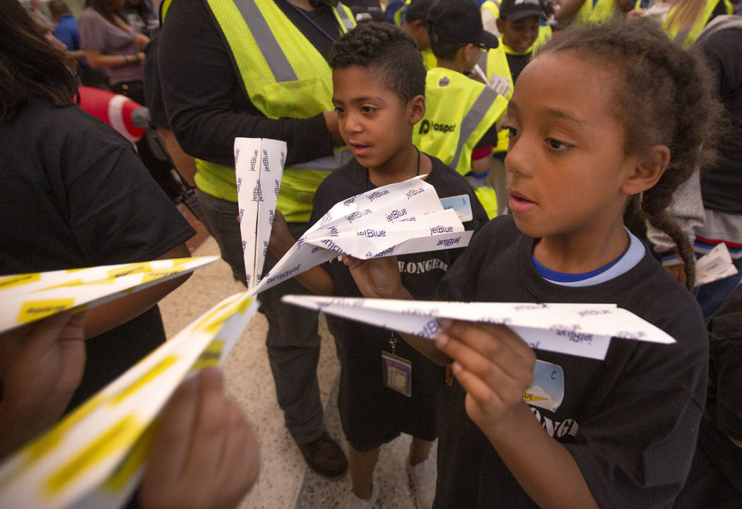 Teammates Adrian Bautista, 7, left, and Shanti Stanley, 7, right, look at the sizes of their pa ...