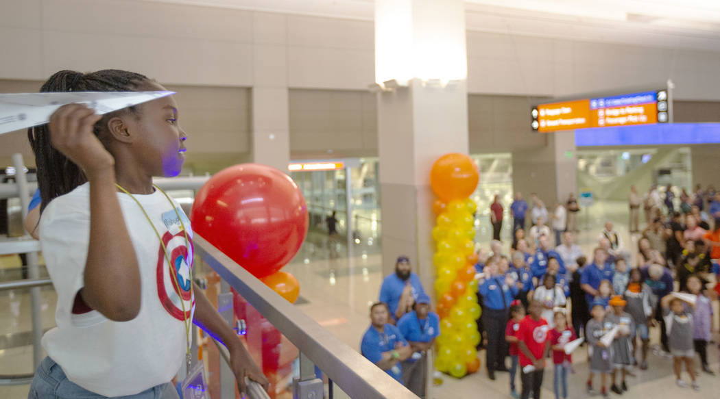 Mahogany Robinson, 9, throws a paper plane during the seventh annual Paper Plane Palooza in Ter ...