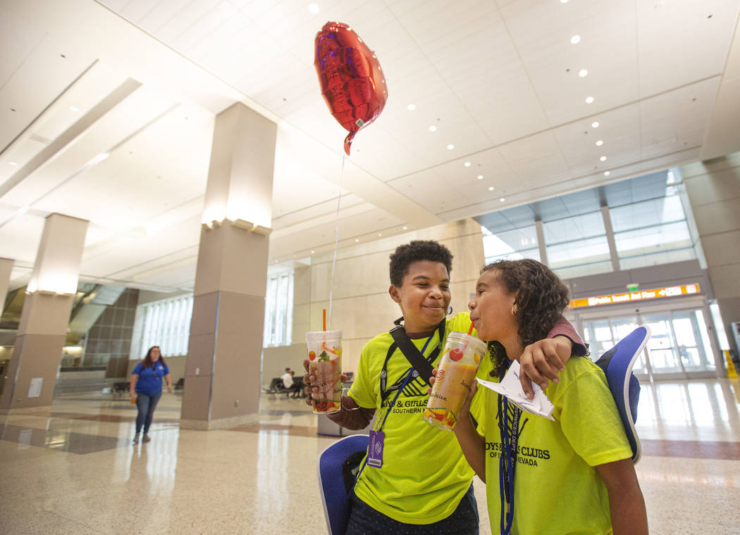 Anwuan Ferguson, 12, drinks a smoothie with fellow teammate, Malia English, 8, during the seven ...