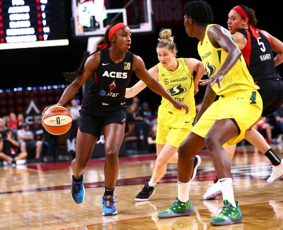 Las Vegas Aces' Jackie Young brings the ball up court against Seattle Storm during the first ha ...
