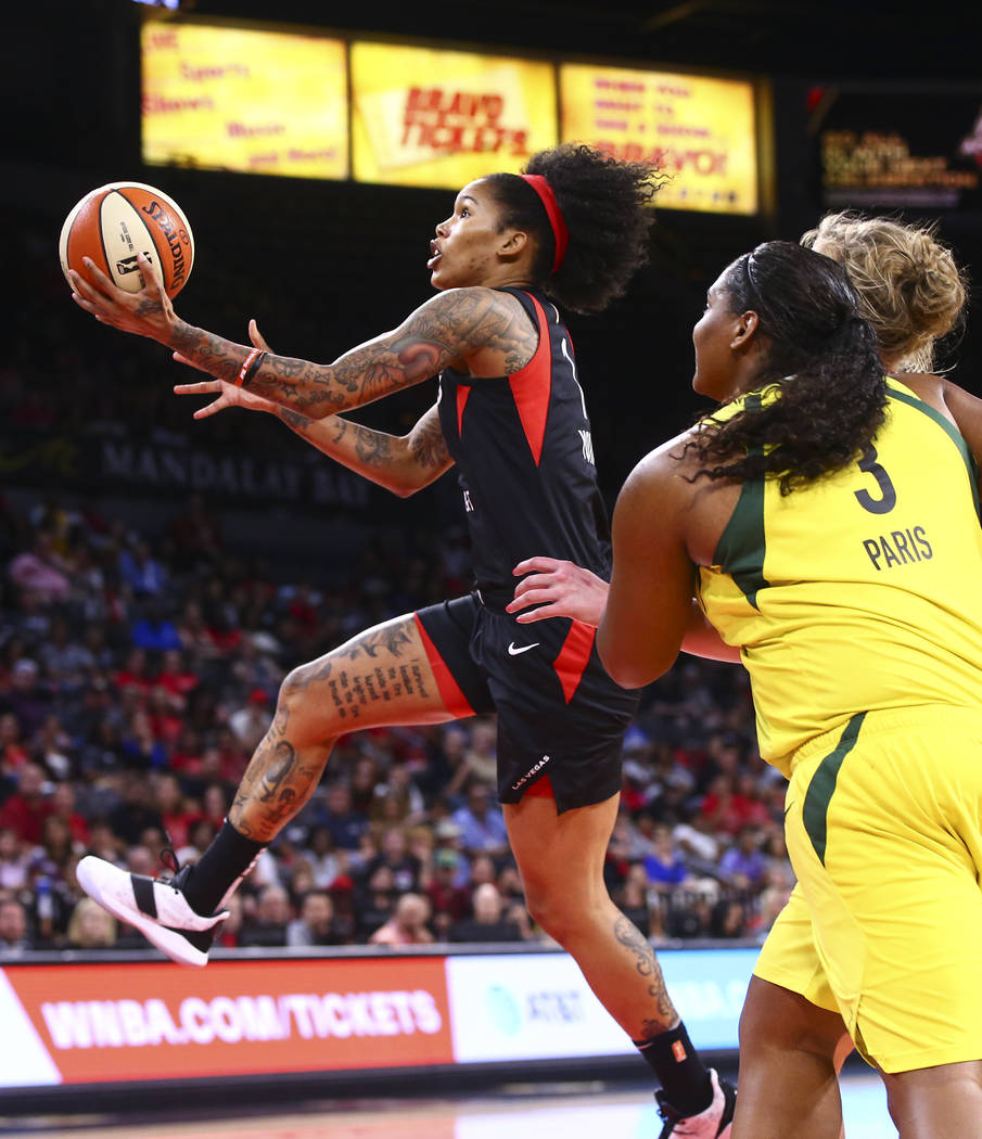 Las Vegas Aces' Tamera Young goes to the basket past Seattle Storm's Courtney Paris (3) during ...