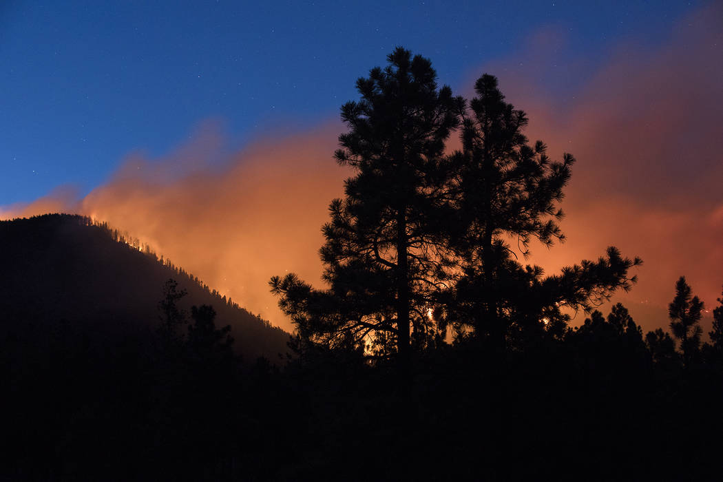 In this Sunday, July 21, 2019, photo, a wildfire burns through the Coconino National Forest, no ...