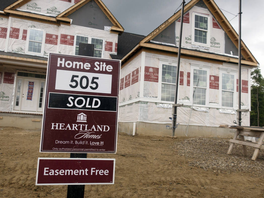 In this May 26, 2019, photo a sold sign is in front of home under construction in Wexford, Pa. ...