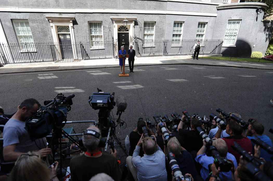 Britain's Prime Minister Theresa May is watched by her husband Philip as she speaks outside 10 ...