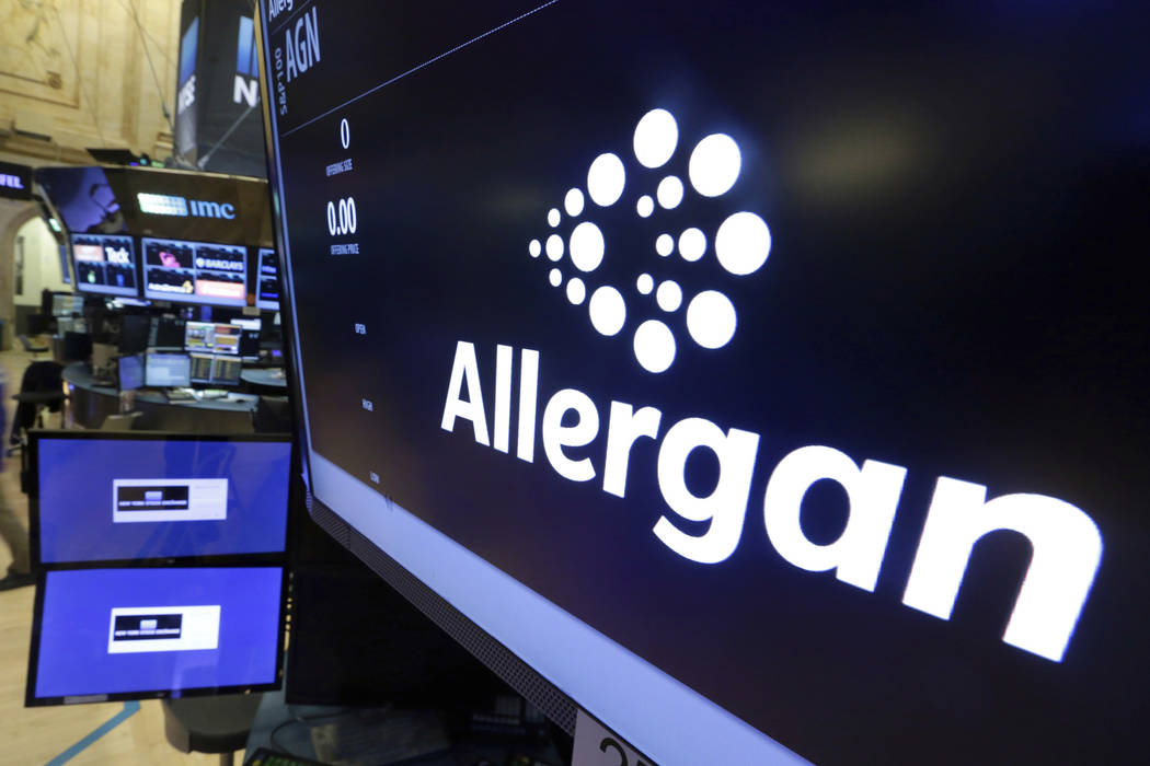 In a Monday, Nov. 23, 2015, file photo, the Allergan logo appears above a trading post on the f ...