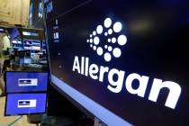 In a Monday, Nov. 23, 2015, file photo, the Allergan logo appears above a trading post on the f ...