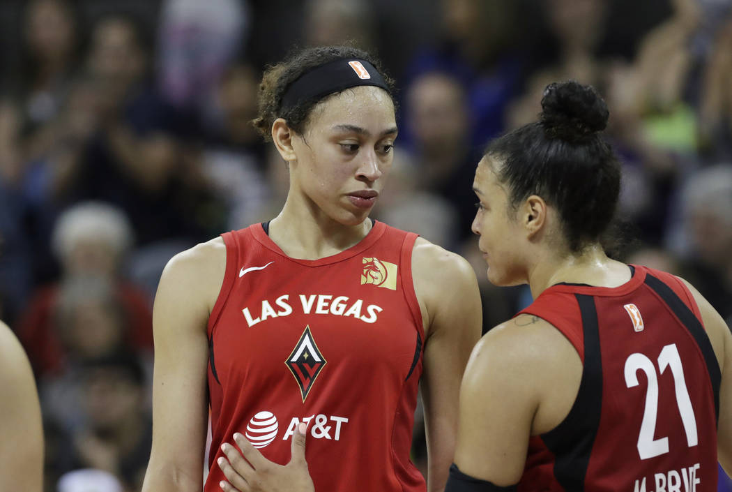 Las Vegas Aces' Dearica Hamby, left, talks with Kayla McBride (21) during a break against the S ...