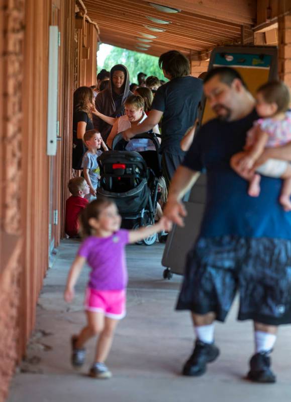 The line of people stays steady for a back-to-school event at the Derfelt Senior Center in Las ...