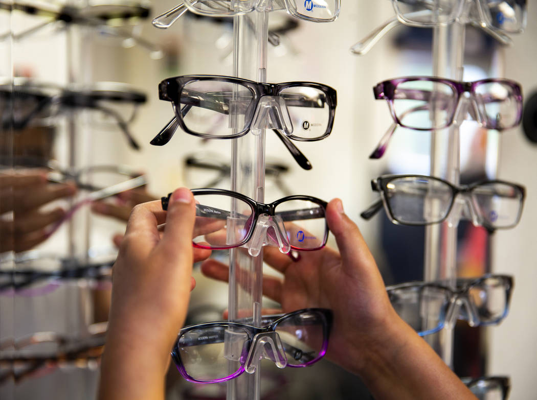 Esther Espinoza, 10, looks for a new pair of glasses during a back-to-school event at the Derfe ...