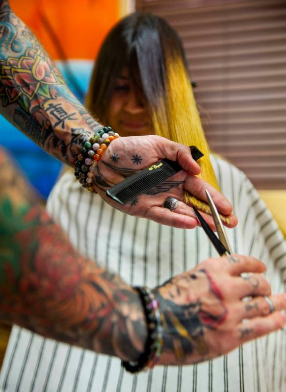 Larissa Garcia has her hair cut by stylist Ryan Glassford during a back-to-school event at the ...