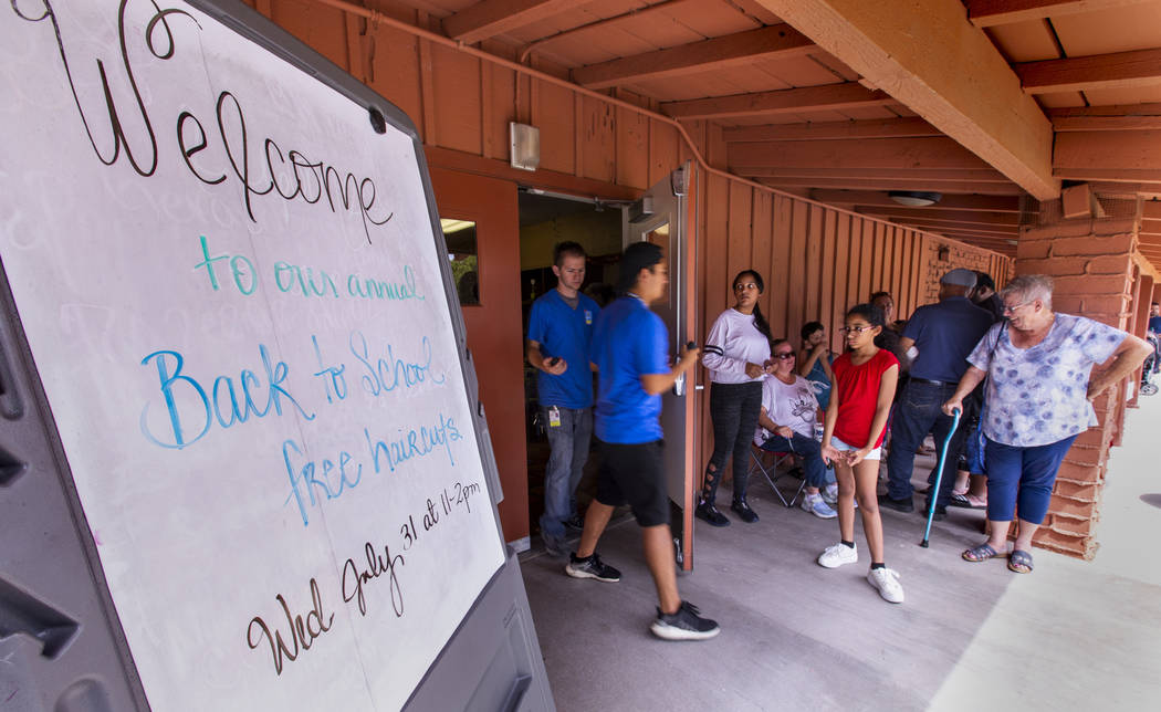 The line of people stays steady for a back-to-school event at the Derfelt Senior Center in Las ...