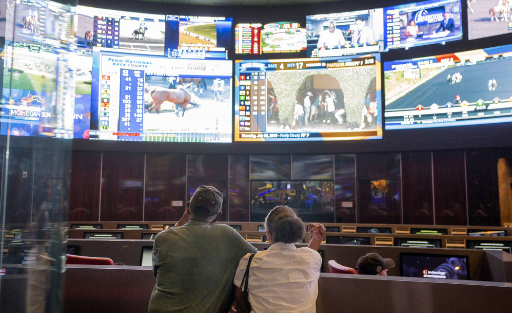 Bettors watch live sports at the CG Technology sportsbook at the Palms in Las Vegas, Thursday, ...