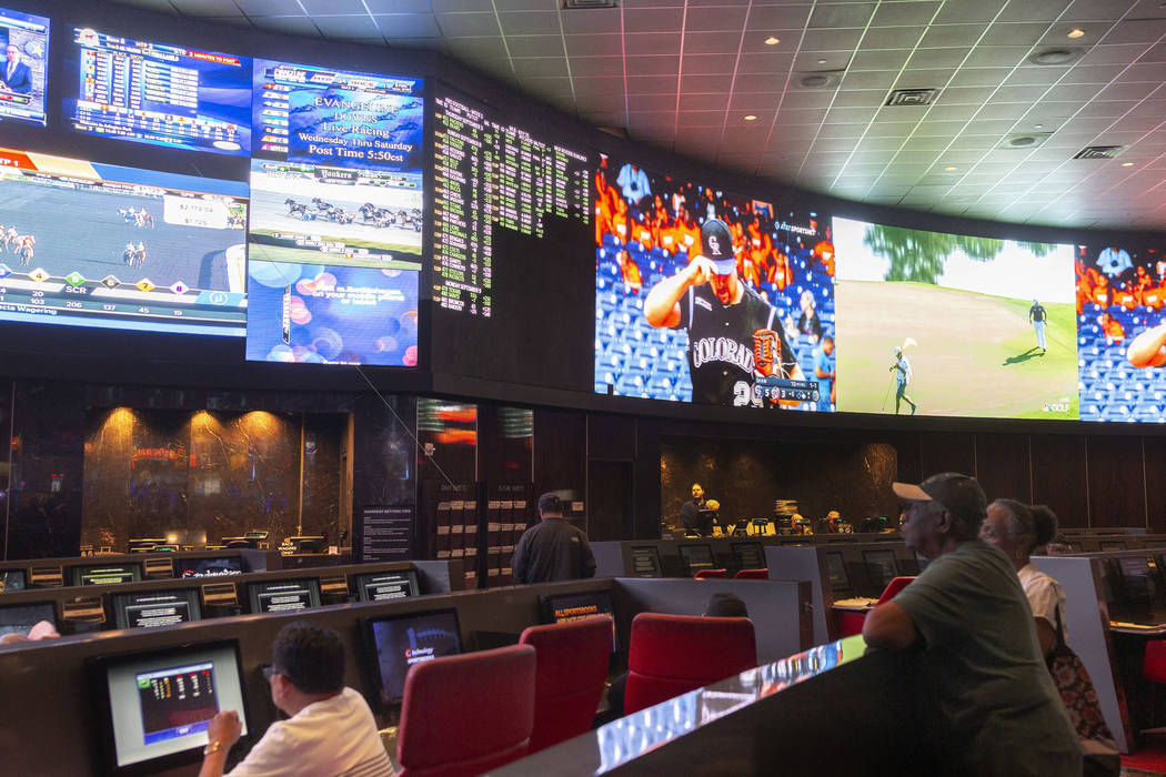 Bettors watch live sports at the CG Technology sportsbook at the Palms in Las Vegas, Thursday, ...