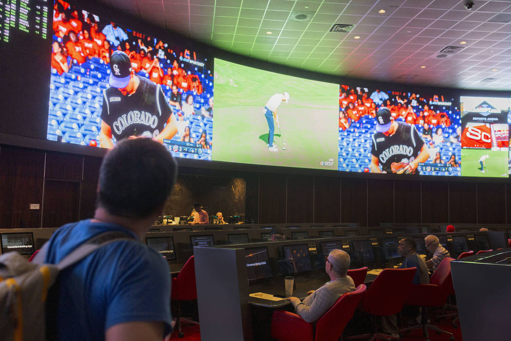 Bettors watch live sports at the CG Technology sportsbook at the Palms in Las Vegas, Thursday, ...