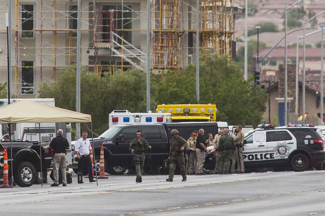 Las Vegas police respond to a barricade situation near Fort Apache and Russell roads in Las Veg ...