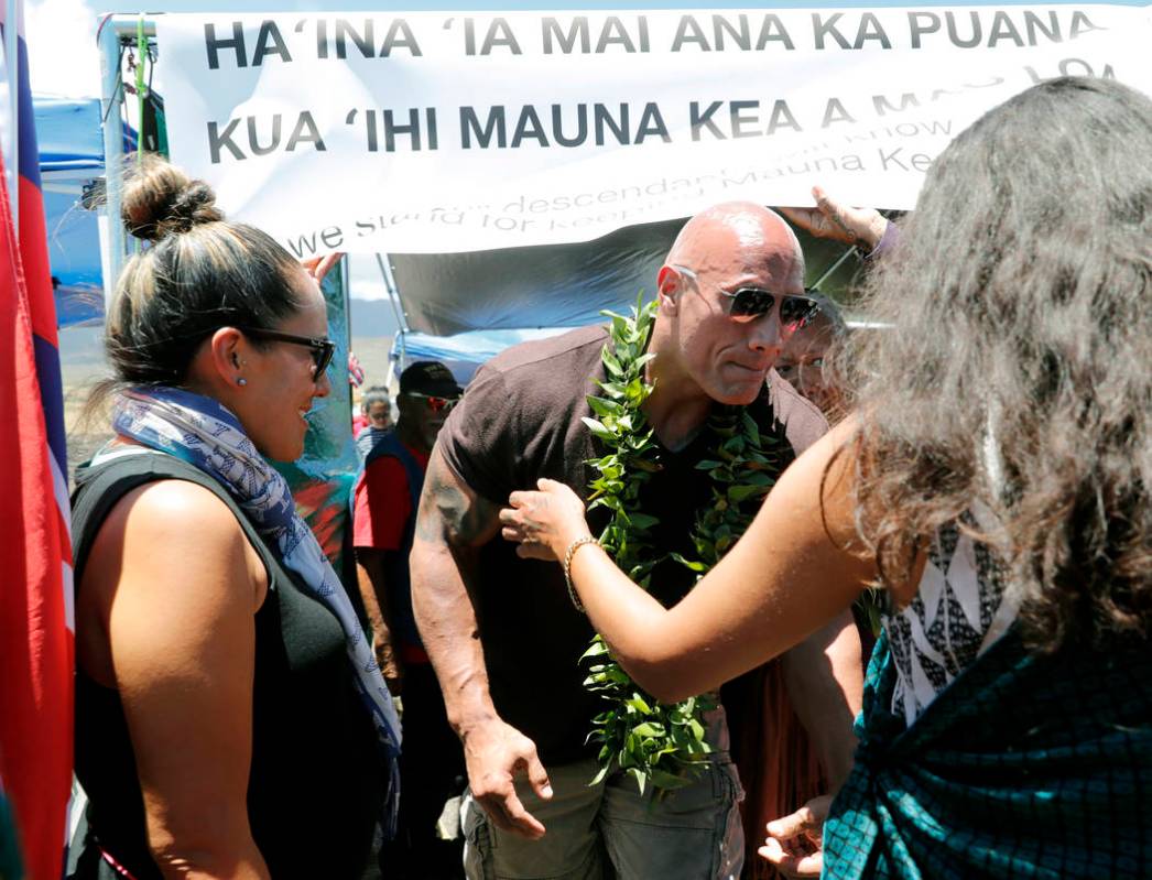 Actor Dwayne "The Rock" Johnson visits with kupuna, an honored elder, during a visit ...