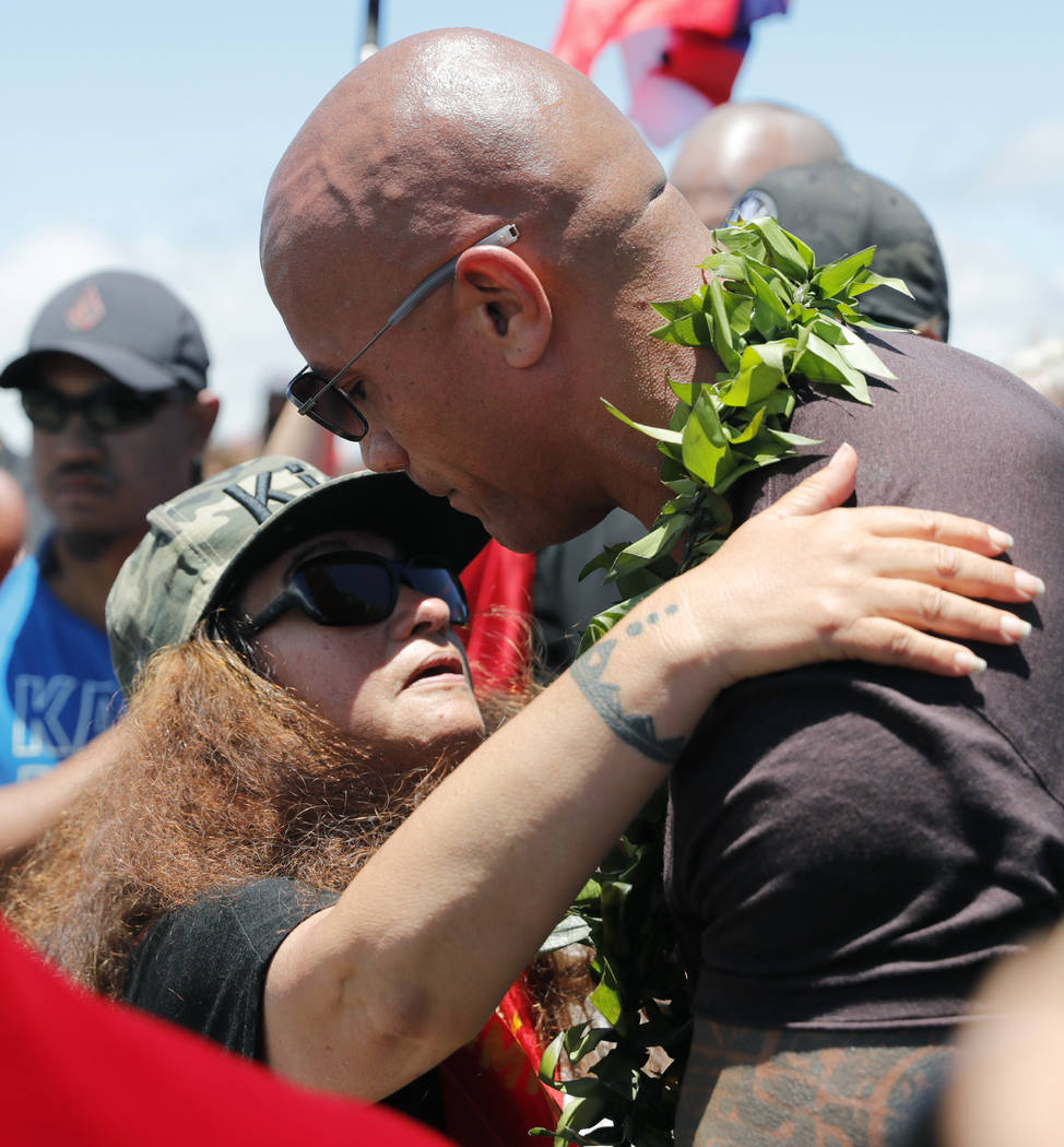 Actor Dwayne "The Rock" Johnson, right, is greeted by community leader Pua Case durin ...